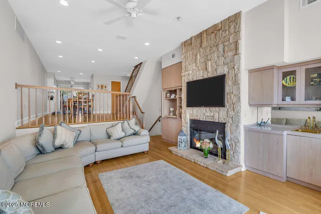 a kitchen with stainless steel appliances kitchen island granite countertop a refrigerator and a stove top oven