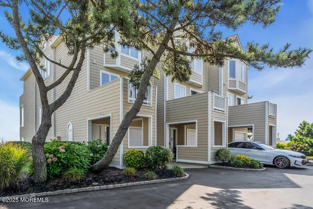 a car parked in front of a white house