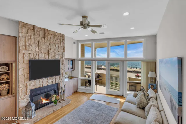 a living room with furniture a flat screen tv and a fireplace
