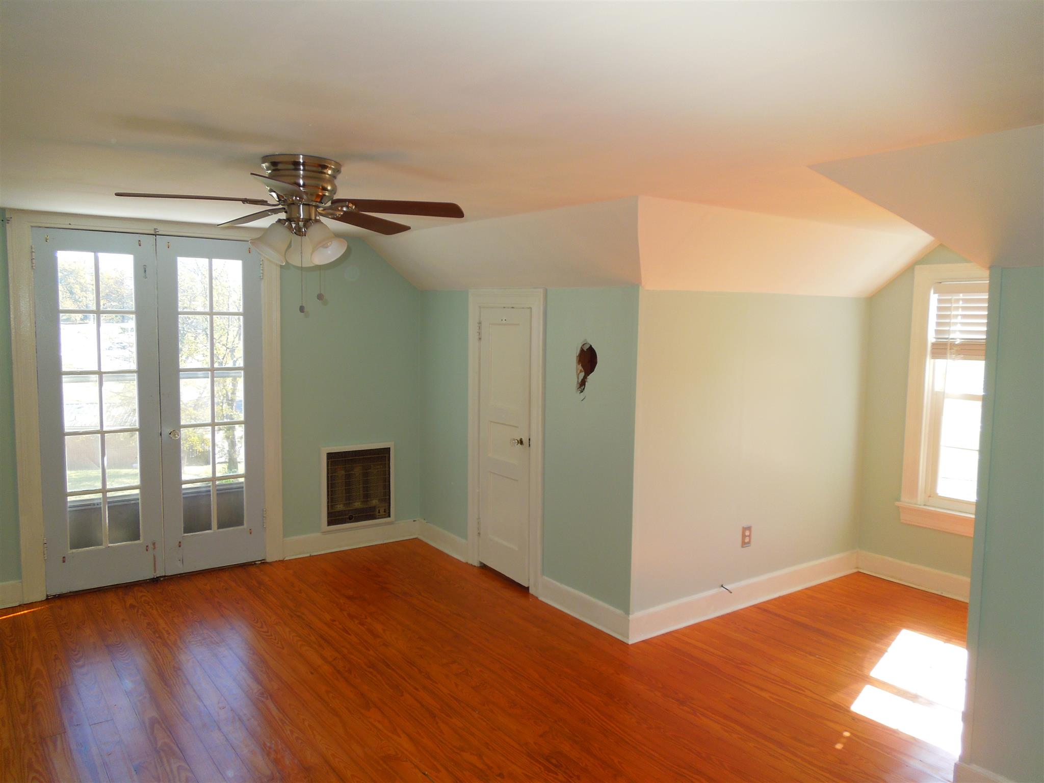 336 Pulaski Street Lawrenceburg, TN 38464 - Photo 14 of 20 a view of an empty room with window and wooden floor