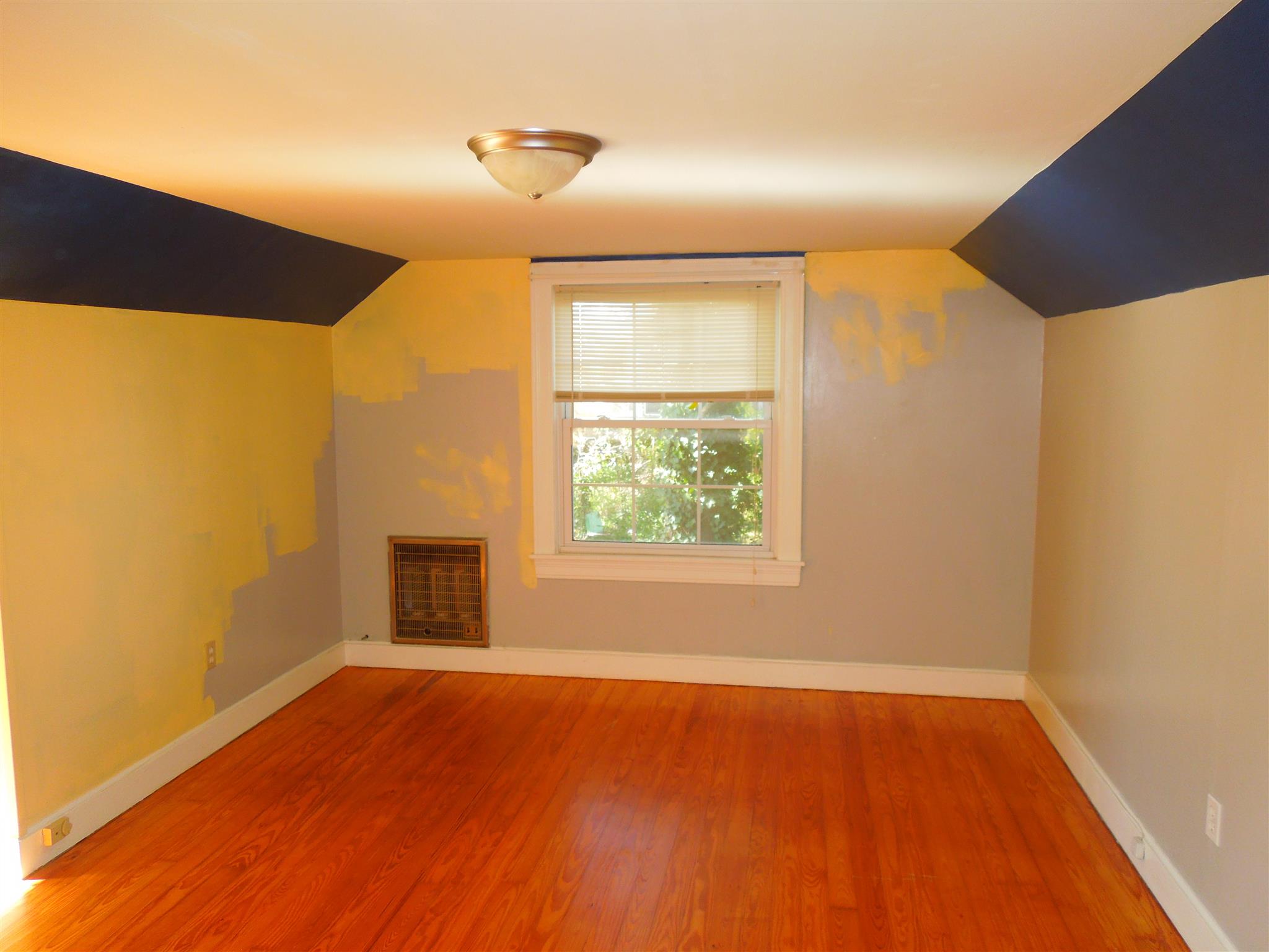 336 Pulaski Street Lawrenceburg, TN 38464 - Photo 16 of 20 a view of an empty room with wooden floor and a window