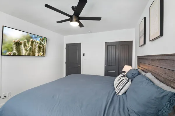 a bedroom with a bed and a painting on the wall