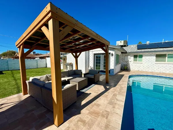 a view of living room kitchen with patio and wooden fence