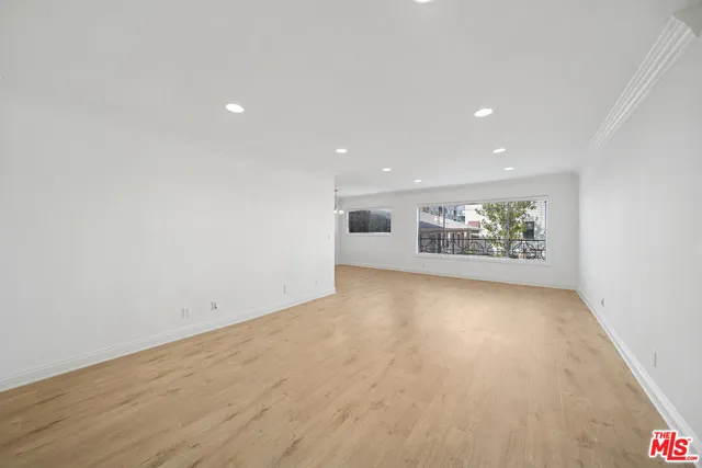 an empty room with a empty space and windows