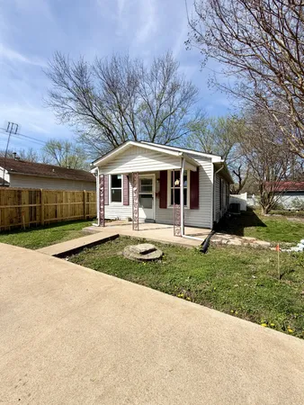 a front view of a house with yard and green space