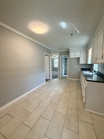 a view of a kitchen with a sink and cabinets