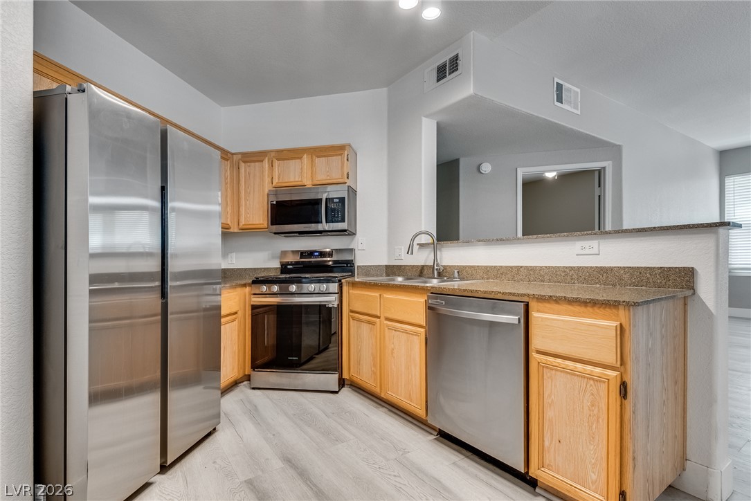 10550 West Alexander Road, Unit 1139 Las Vegas, NV 89129 - Photo 11 of 27 Culinary delights await in this modern kitchen with stainless steel appliances and ample counter space.