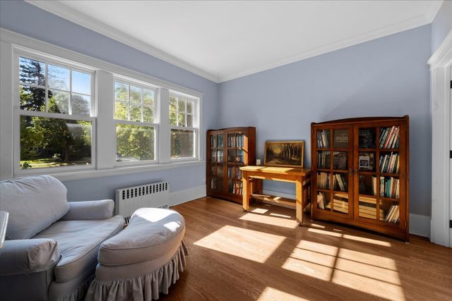 a living room with furniture a window and a flat screen tv
