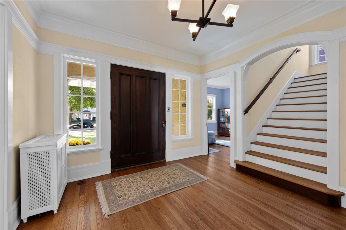 611 Ash Street Winnetka, IL 60093 - Photo 24 of 43 a view of a hallway with wooden floor and stairs
