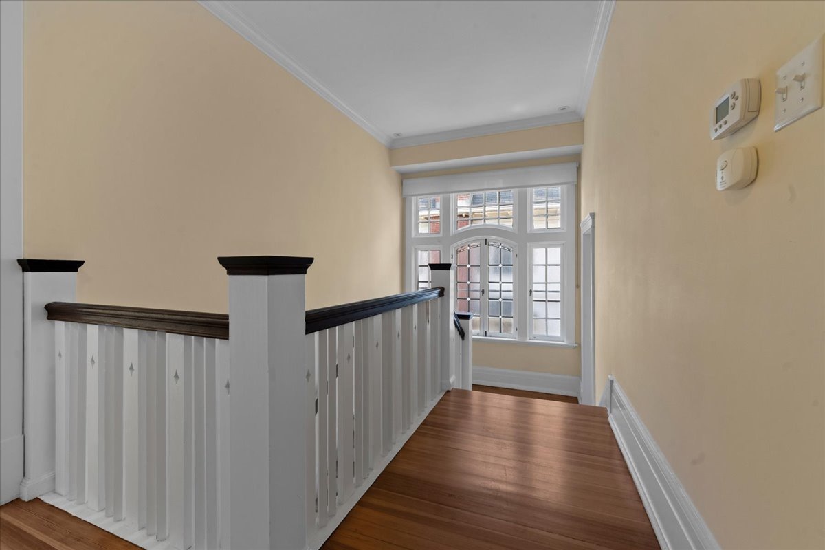 611 Ash Street Winnetka, IL 60093 - Photo 25 of 43 a view of a hallway with wooden floor and staircase