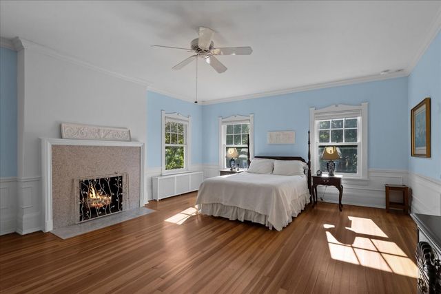 a spacious bedroom with a bed and a fireplace