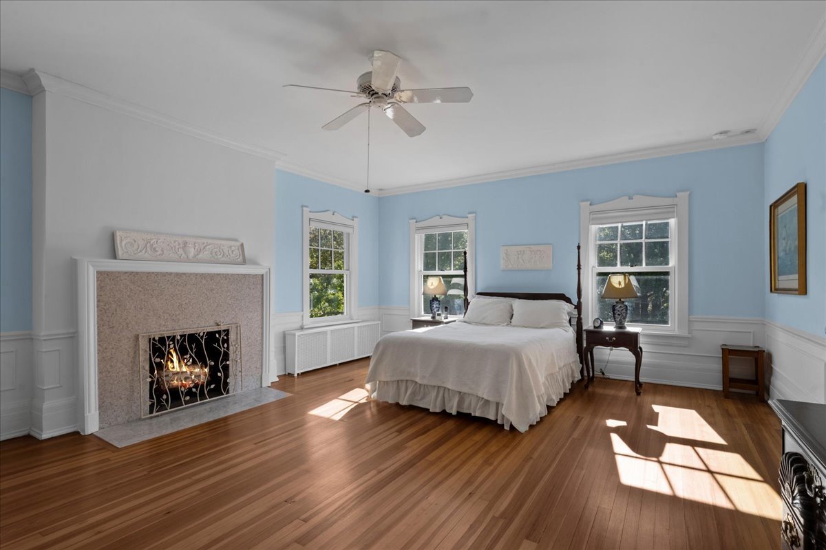 611 Ash Street Winnetka, IL 60093 - Photo 26 of 43 a spacious bedroom with a bed and a fireplace