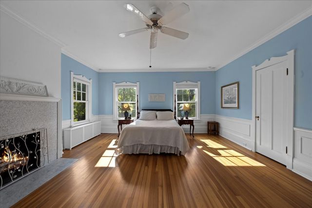 a spacious bedroom with a bed and a fireplace