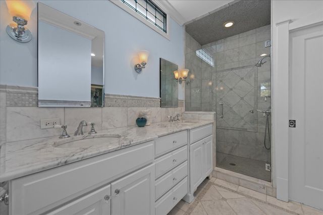 a bathroom with a shower sink and mirror