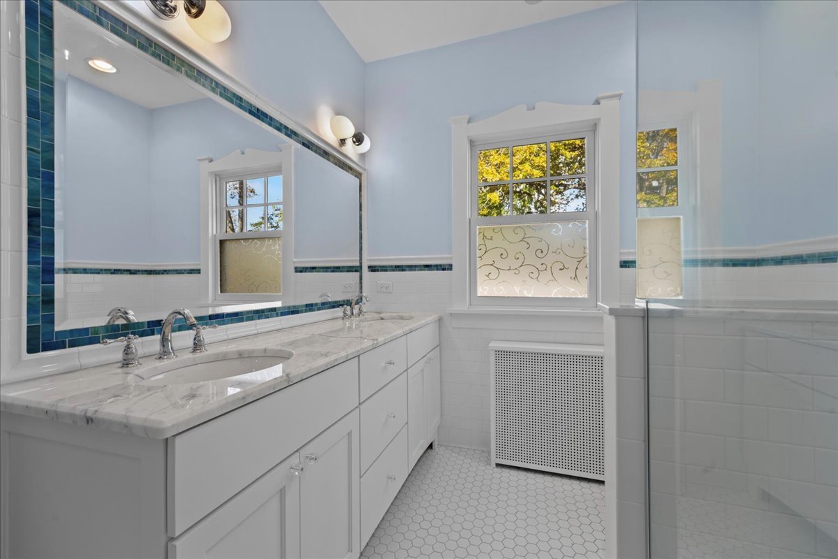611 Ash Street Winnetka, IL 60093 - Photo 33 of 43 a bathroom with a sink and a mirror