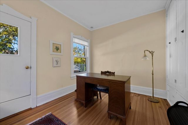 a view of a workspace with furniture and wooden floor