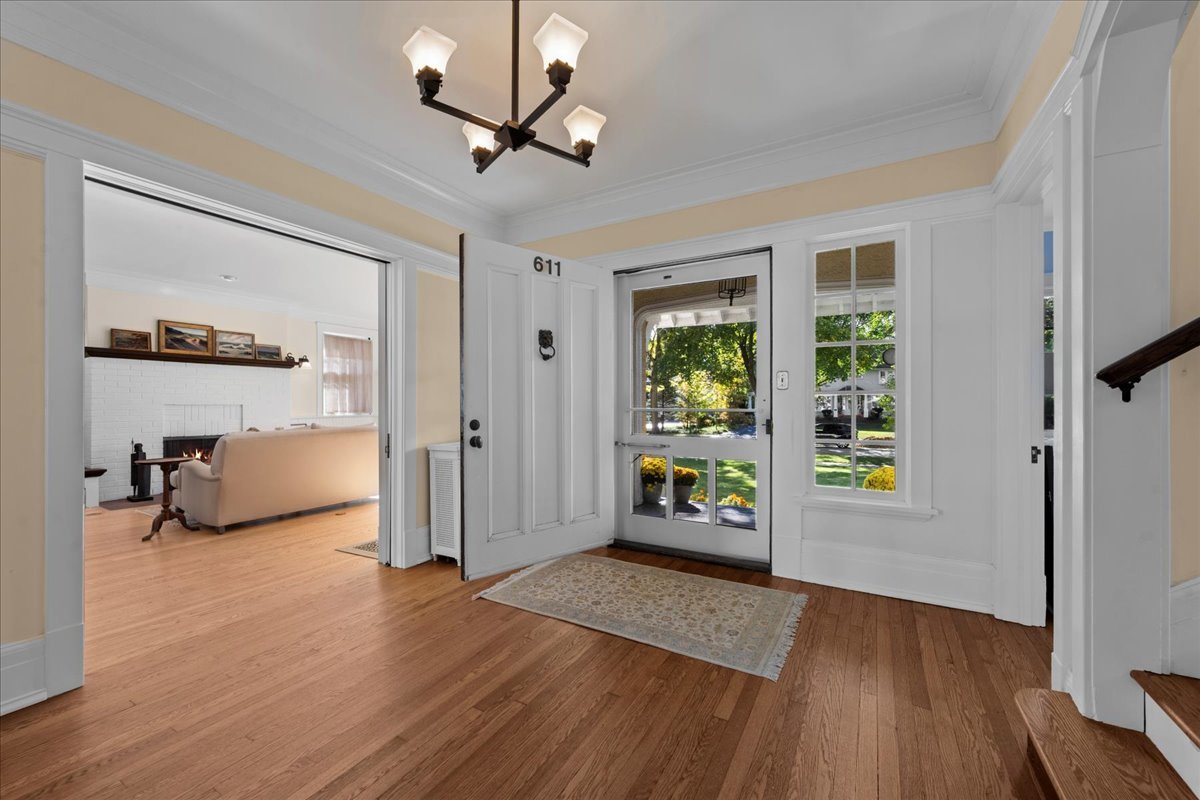 611 Ash Street Winnetka, IL 60093 - Photo 4 of 43 a view of an empty room with a window and wooden floor