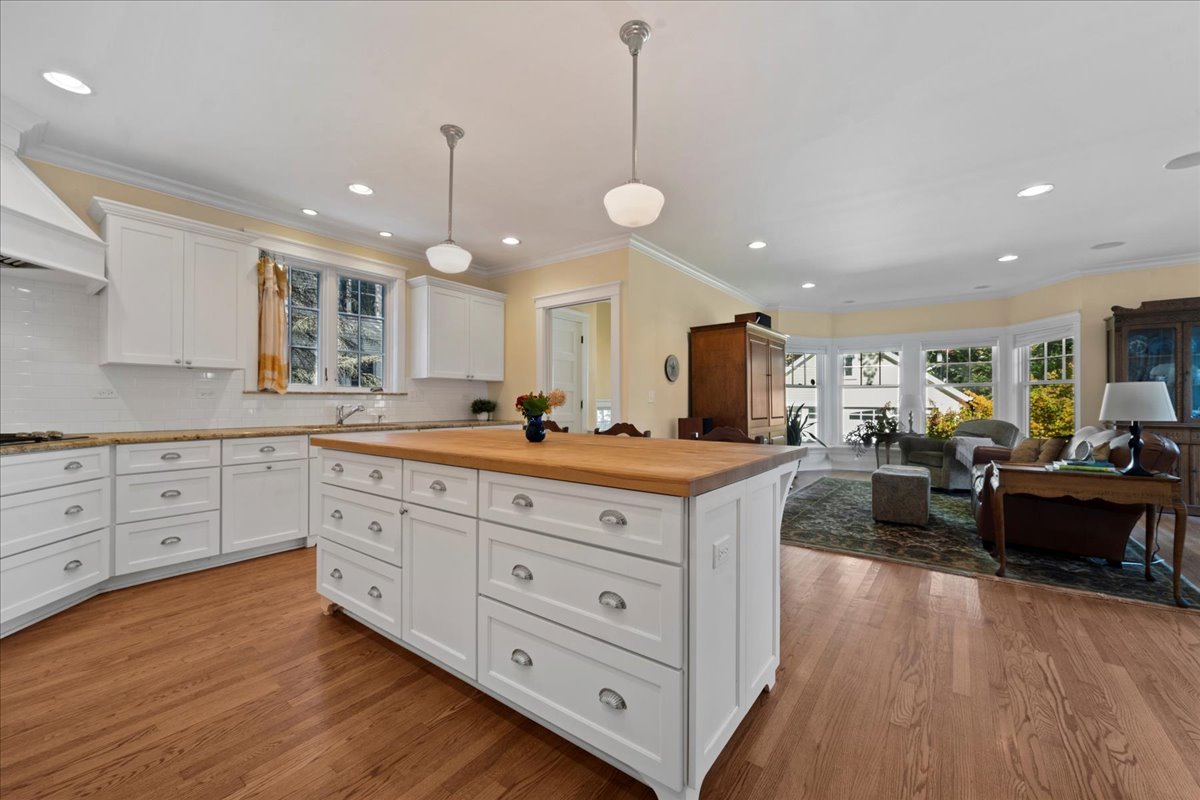 611 Ash Street Winnetka, IL 60093 - Photo 8 of 43 a large living room with stainless steel appliances granite countertop a couch and a large window