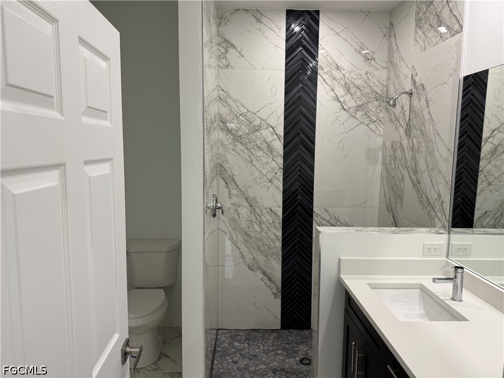 3203 24th Street Southwest Lehigh Acres, FL 33976 - Photo 4 of 19 a bathroom with a sink and a mirror