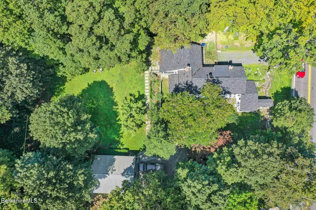 an aerial view of a house with a yard
