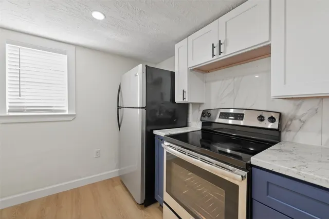 a kitchen with a stove microwave and refrigerator