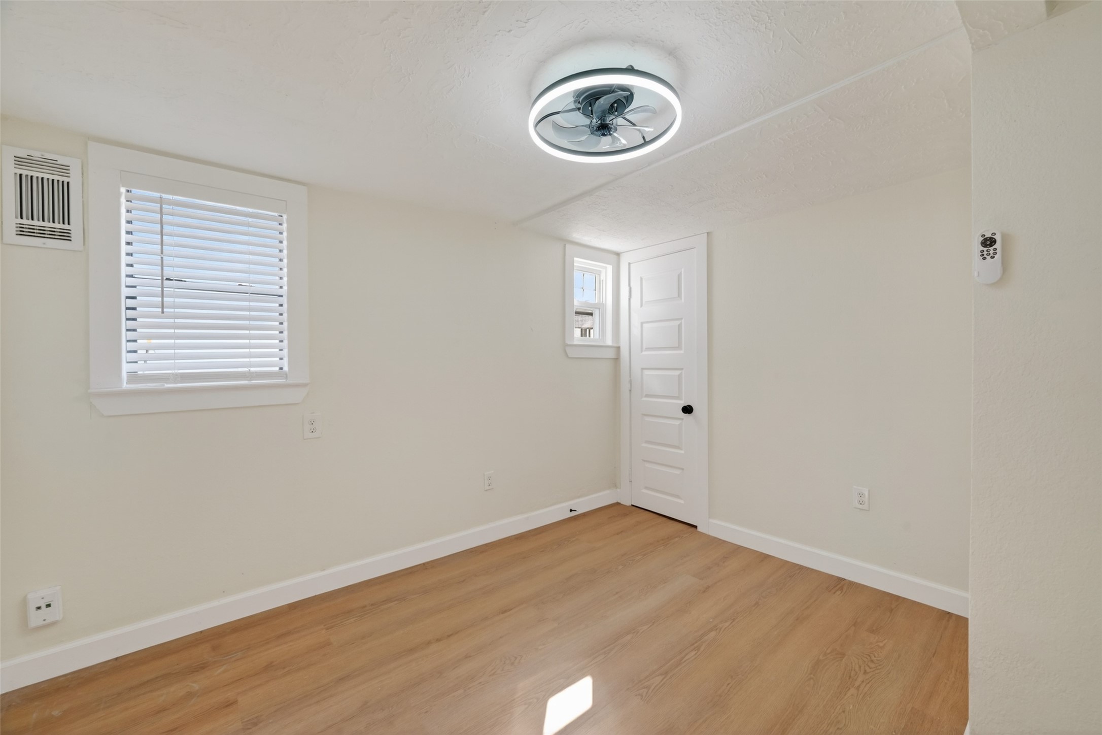 2118 Webster Street, Unit 3 Houston, TX 77003 - Photo 16 of 24 an empty room with a wooden floor and a window