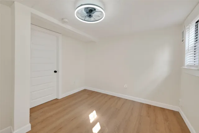 a view of a room with wooden floor