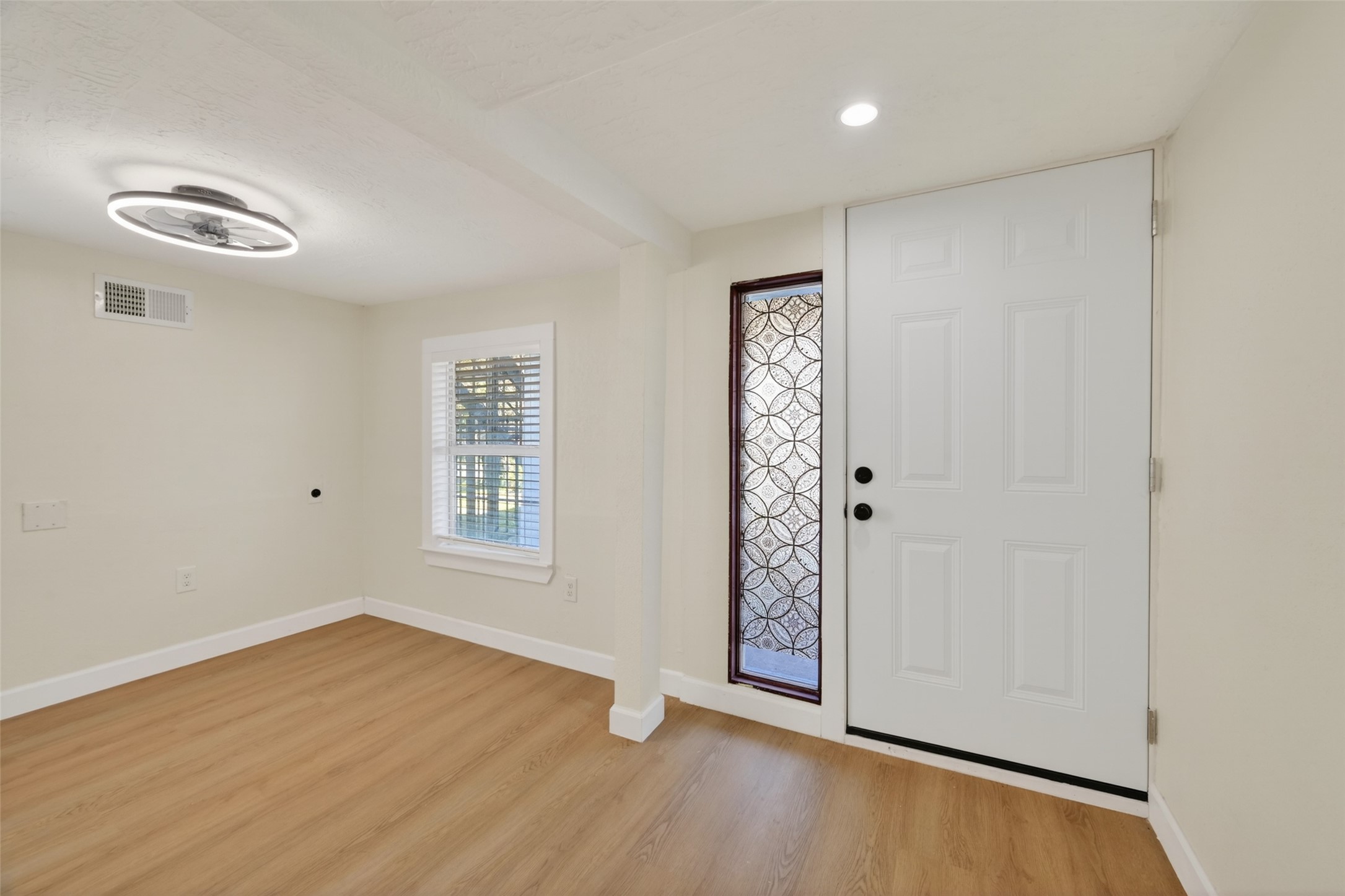 2118 Webster Street, Unit 3 Houston, TX 77003 - Photo 3 of 24 an empty room with wooden floor cabinet and windows