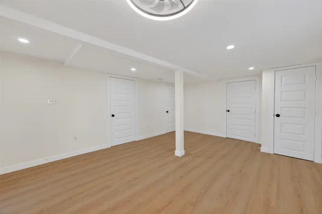 a view of an empty room with wooden floor