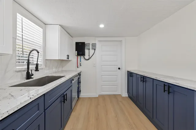 a kitchen with granite countertop a sink and a stove top oven
