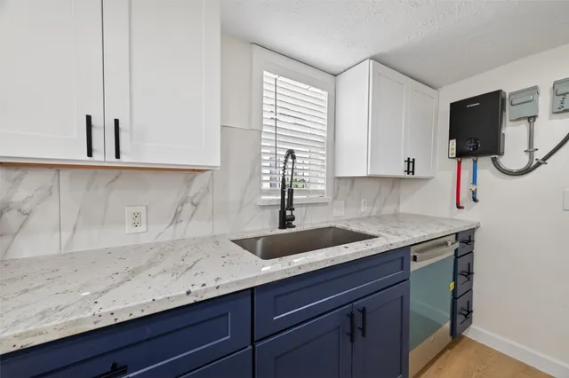 a kitchen with a sink and cabinets