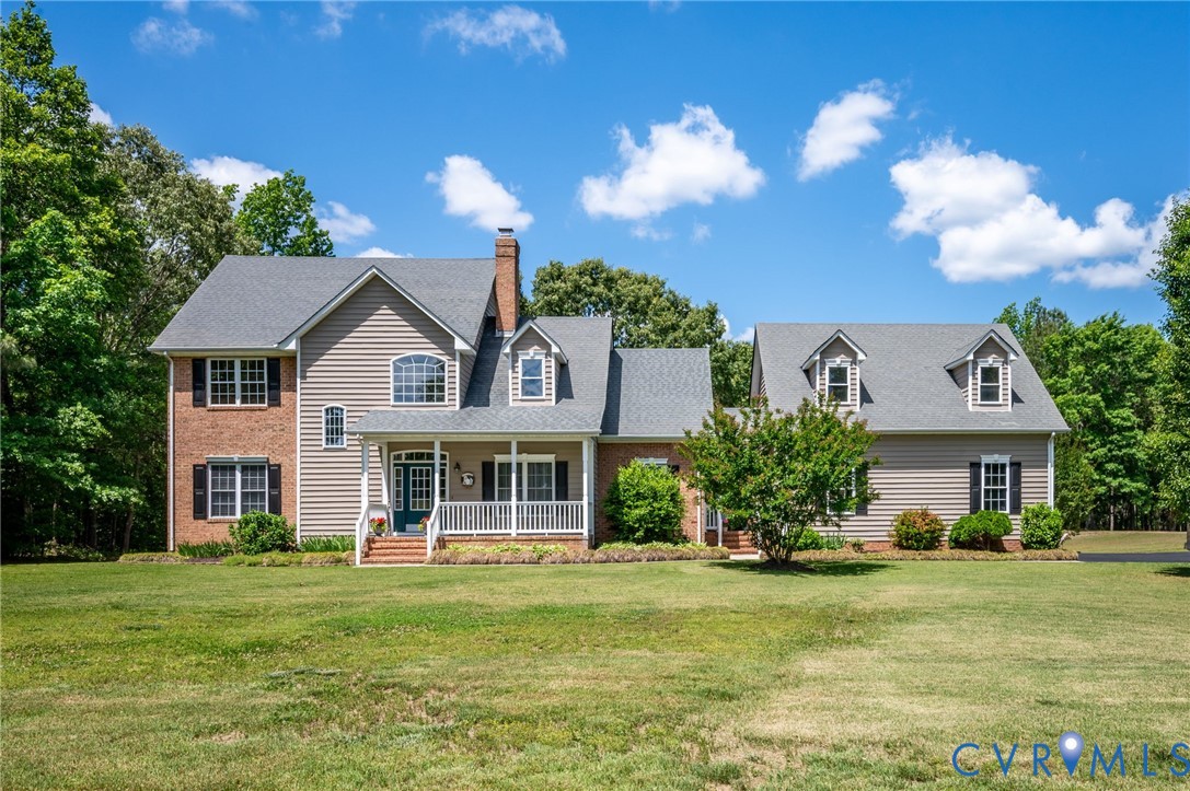 17170 Templeton Road Disputanta, VA 23842 - Photo 1 of 27 a front view of a house with a garden