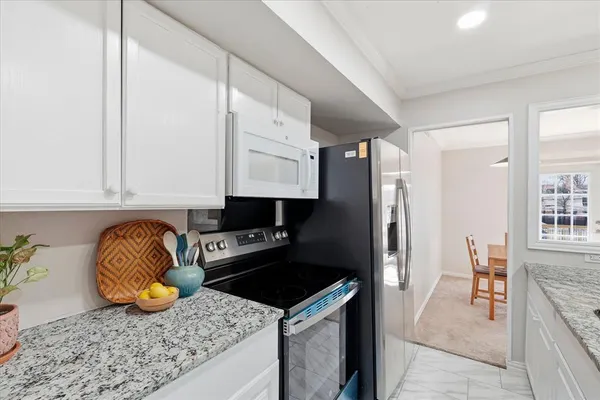 a kitchen with stainless steel appliances granite countertop a sink and cabinets