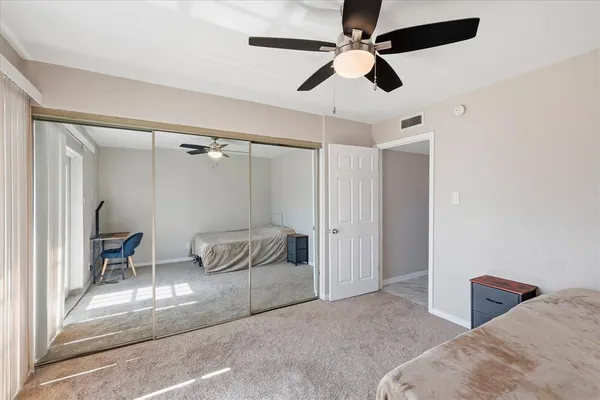 a bathroom with a granite countertop sink toilet a mirror and shower