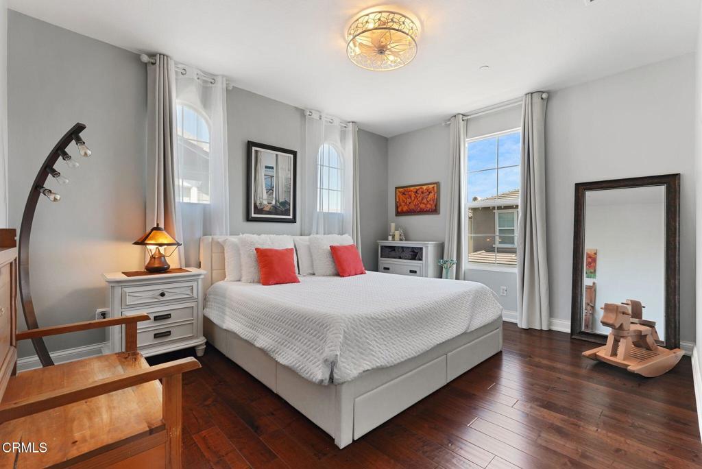 1424 Donegal Way Oxnard, CA 93035 - Photo 25 of 64 a bedroom with a bed and a chandelier