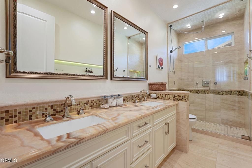 1424 Donegal Way Oxnard, CA 93035 - Photo 30 of 64 a bathroom with a sink and a mirror