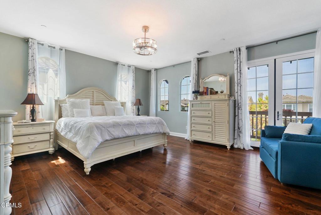 1424 Donegal Way Oxnard, CA 93035 - Photo 37 of 64 a bedroom with a bed and wooden floor