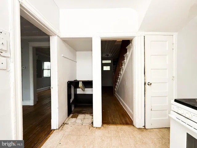 a view of hallway with closet and wooden floor