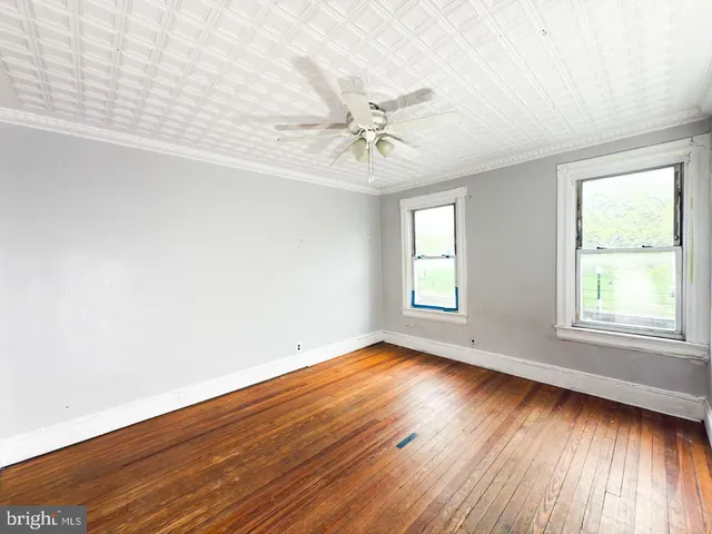 a view of a ceiling fan and wooden floor