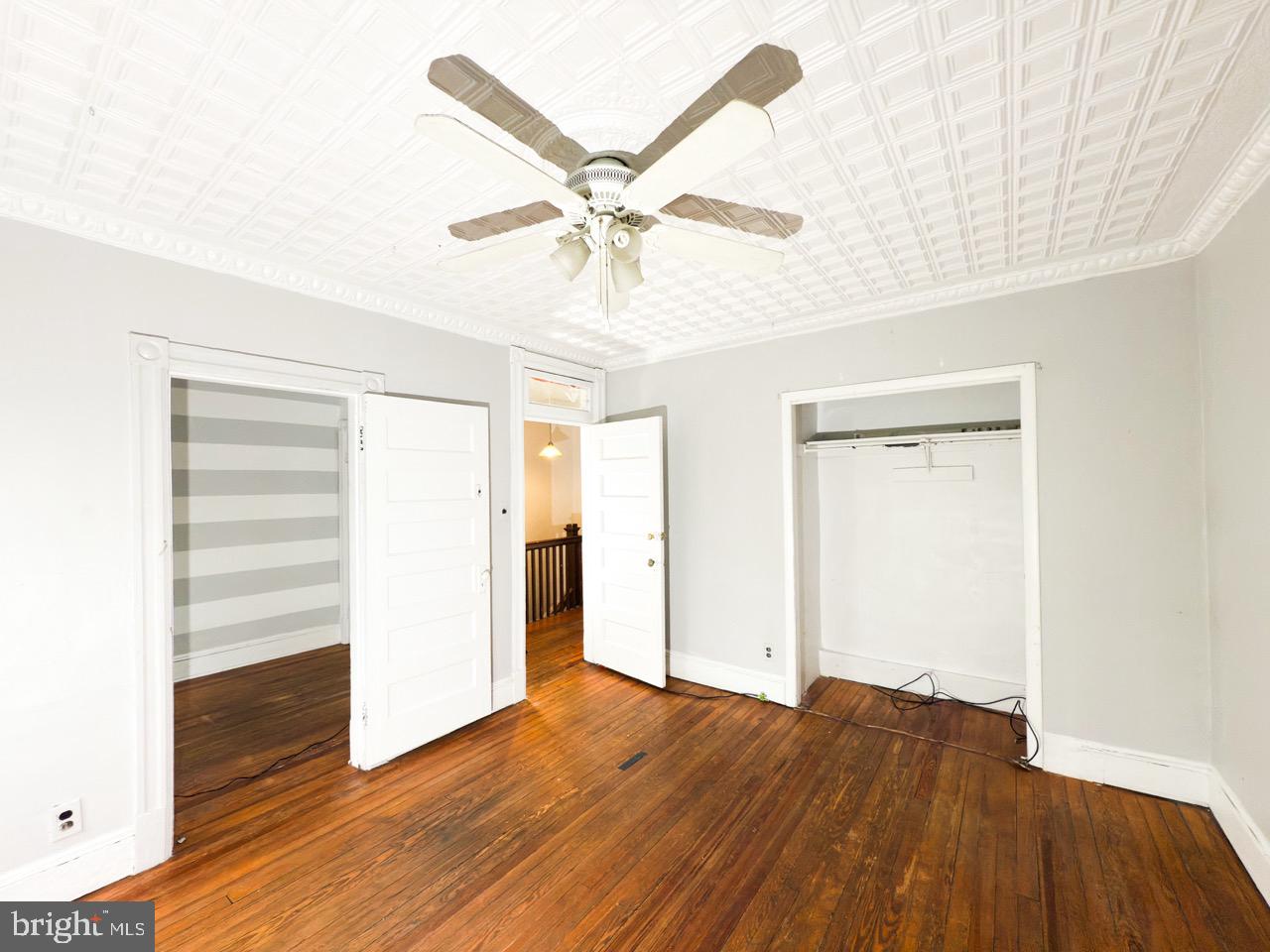 711 Florida Avenue Northeast Washington, DC 20002 - Photo 20 of 46 a view of a livingroom with wooden floor and a ceiling fan