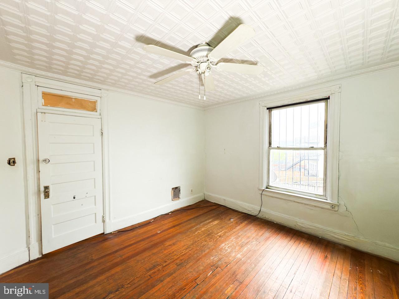 711 Florida Avenue Northeast Washington, DC 20002 - Photo 25 of 46 an empty room with wooden floor closet and windows