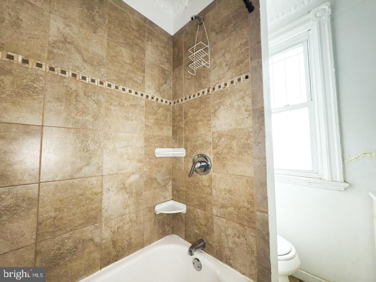 711 Florida Avenue Northeast Washington, DC 20002 - Photo 28 of 46 a bathroom with a toilet a sink and shower