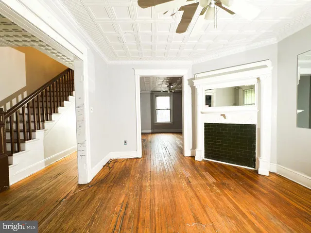 a view of a hallway with wooden floor and a fireplace