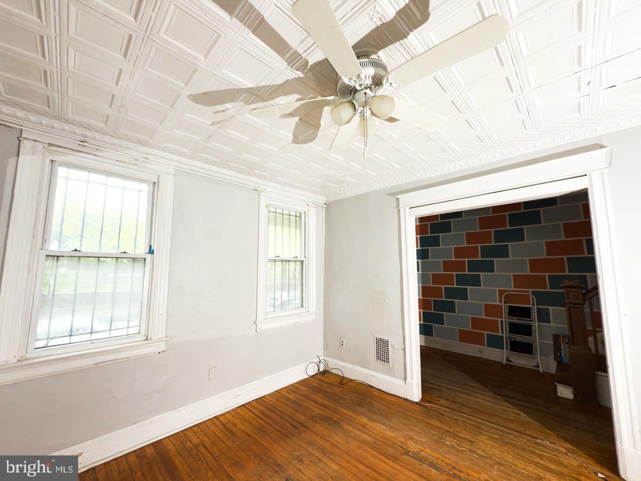 711 Florida Avenue Northeast Washington, DC 20002 - Photo 9 of 46 a view of an empty room with a window and wooden floor