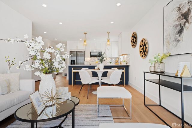 a living room with furniture a rug and white walls