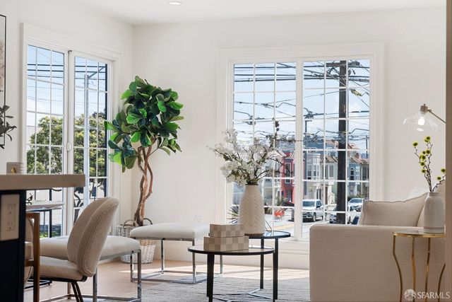a living room with furniture and a potted plant
