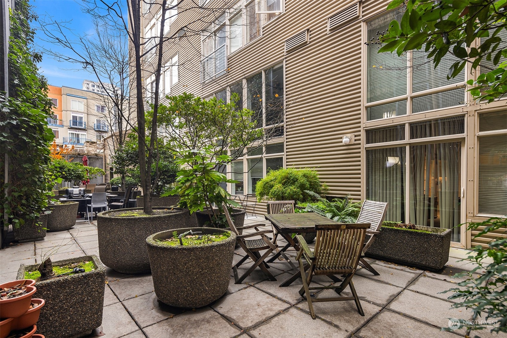 a view of a chair and table in backyard of the house