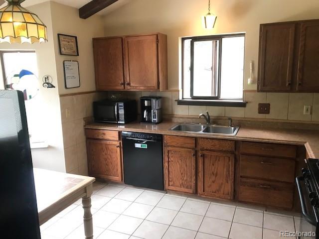 945 Wisp Creek Drive Bailey, CO 80421 - Photo 17 of 26 a kitchen with stainless steel appliances granite countertop a refrigerator and a sink