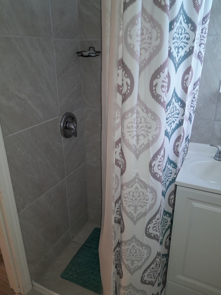 92-8968 Reef Parkway Ocean View, HI 96704 - Photo 7 of 10 a bathroom with a shower and mirror