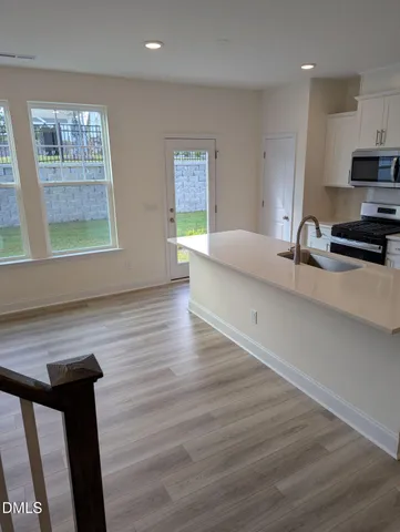 a view of kitchen and sink with wooden floor